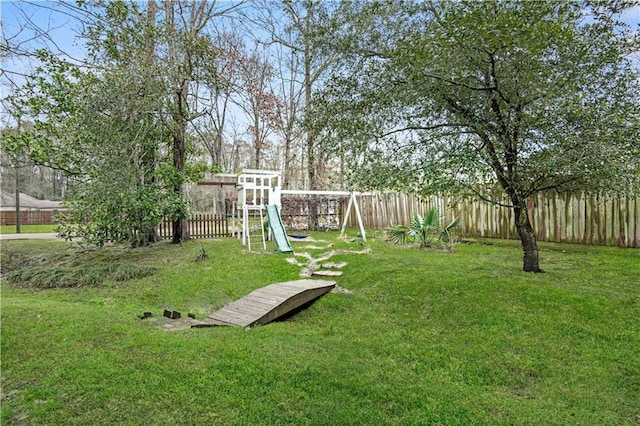 view of yard with a playground and a fenced backyard