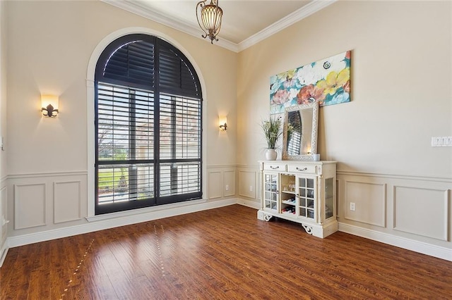 1042 Mariners Cove Blvd, Slidell, LA 70458 - empty room with a decorative wall, crown molding, wood finished floors, a wainscoted wall, and a chandelier