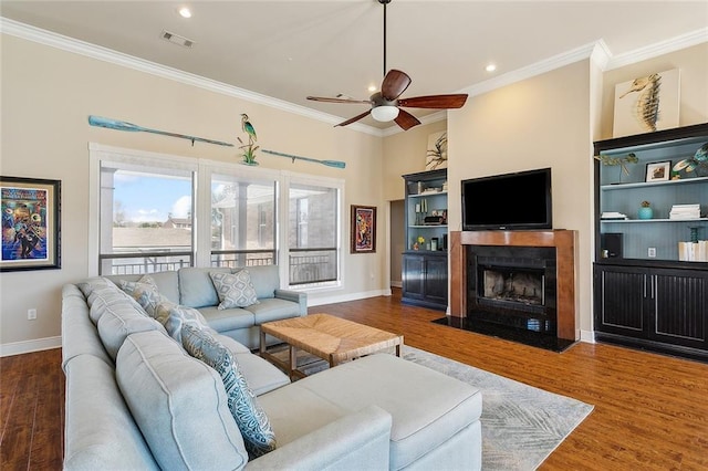 1042 Mariners Cove Blvd, Slidell, LA 70458 - living room featuring crown molding, a ceiling fan, wood finished floors, a fireplace with flush hearth, and recessed lighting