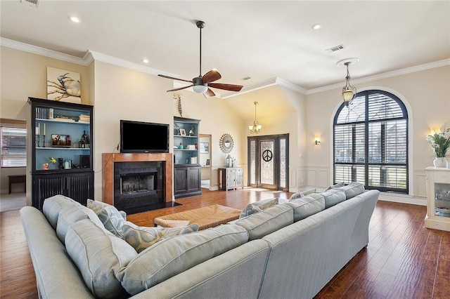 1042 Mariners Cove Blvd, Slidell, LA 70458 - living area with a fireplace with flush hearth, ornamental molding, ceiling fan, wainscoting, and lofted ceiling