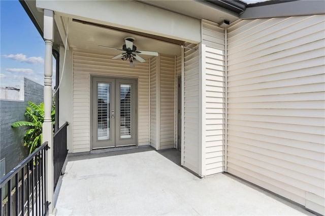 doorway to property featuring a balcony, ceiling fan, and french doors