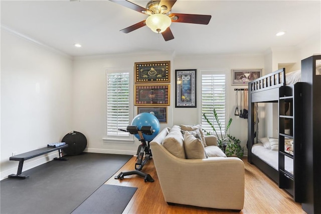 workout area with ceiling fan, recessed lighting, baseboards, light wood-type flooring, and crown molding