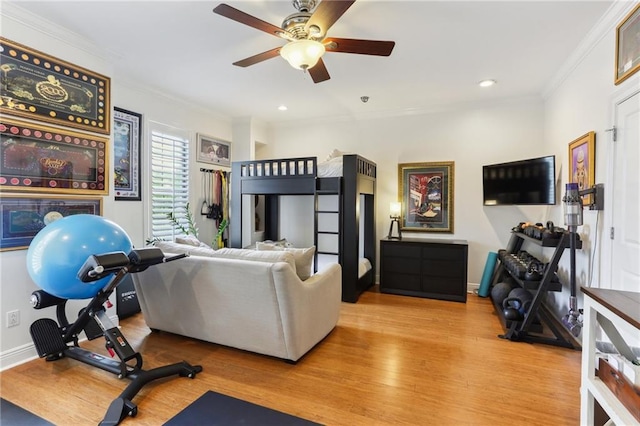 exercise room with light wood finished floors, baseboards, crown molding, and recessed lighting