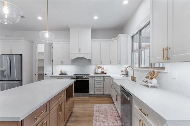 kitchen with white cabinetry, appliances with stainless steel finishes, and a sink