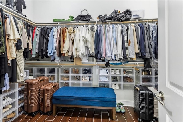 walk in closet with wood finish floors