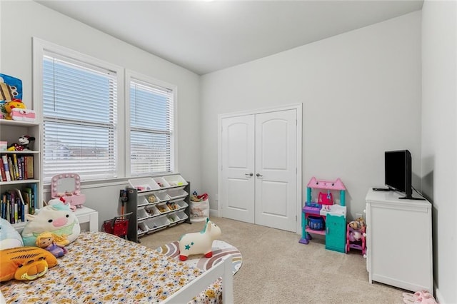 bedroom with a closet and light colored carpet