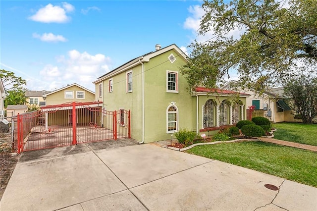 5116 Franklin Ave, New Orleans, LA 70122 - view of front facade with a gate, stucco siding, and driveway