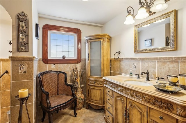 5116 Franklin Ave, New Orleans, LA 70122 - bathroom featuring tile walls, a wainscoted wall, vanity, a chandelier, and tile patterned floors