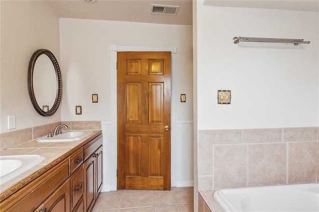 5116 Franklin Ave, New Orleans, LA 70122 - full bath featuring double vanity, a garden tub, and tile patterned flooring