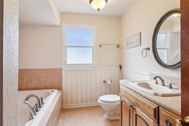5116 Franklin Ave, New Orleans, LA 70122 - full bath featuring toilet, tiled bath, a wainscoted wall, vanity, and tile patterned flooring