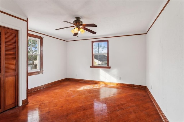 5116 Franklin Ave, New Orleans, LA 70122 - unfurnished bedroom with wood finished floors, baseboards, crown molding, a closet, and a ceiling fan