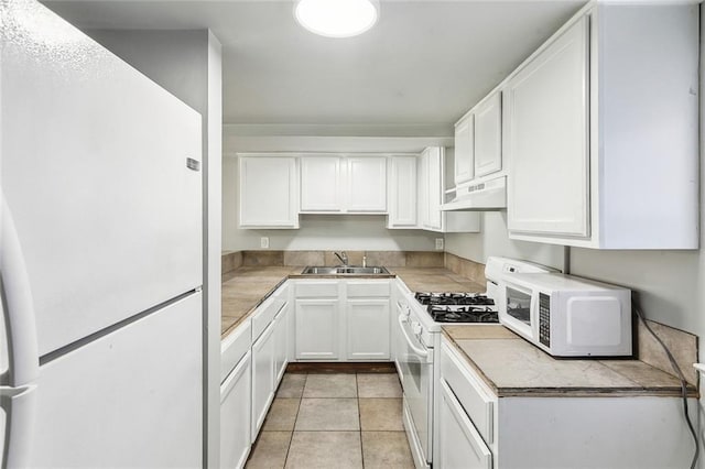 5116 Franklin Ave, New Orleans, LA 70122 - kitchen featuring white appliances, a sink, under cabinet range hood, white cabinetry, and light countertops