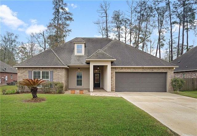 view of front of home with a garage, driveway, a front lawn, and brick siding