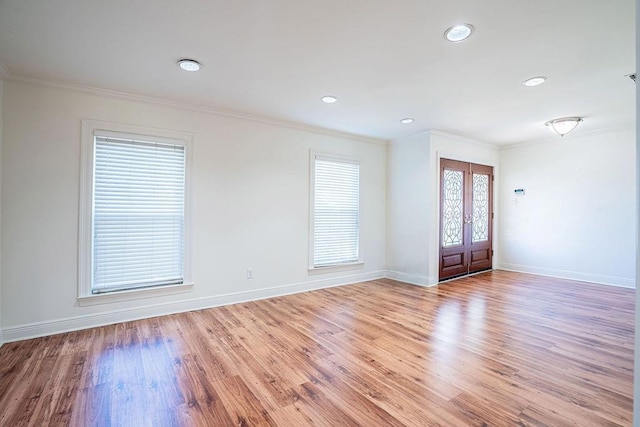 entrance foyer featuring recessed lighting, baseboards, french doors, light wood finished floors, and crown molding