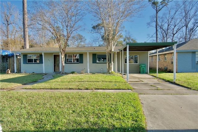 single story home with driveway, a front lawn, and an attached carport