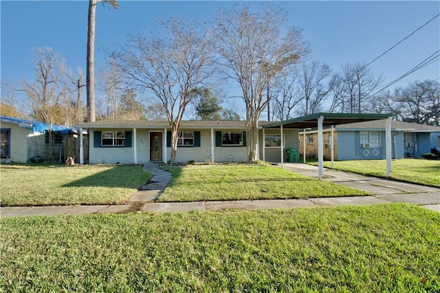 ranch-style home featuring an attached carport, concrete driveway, and a front yard