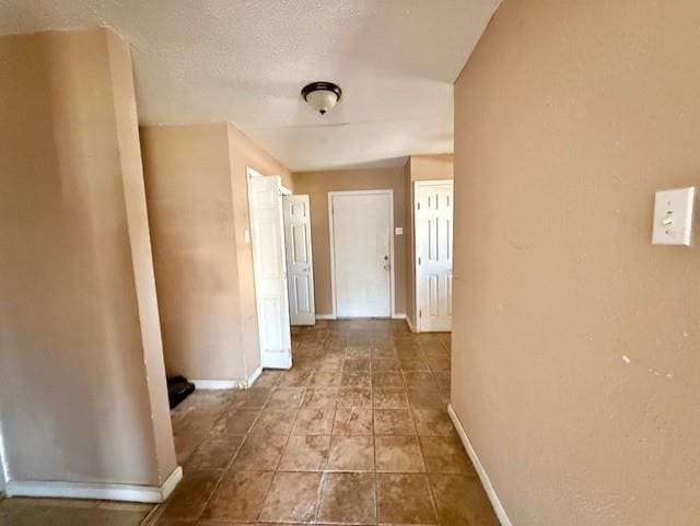 2340 Rex Pl, New Orleans, LA 70125 - hallway featuring a textured ceiling and baseboards