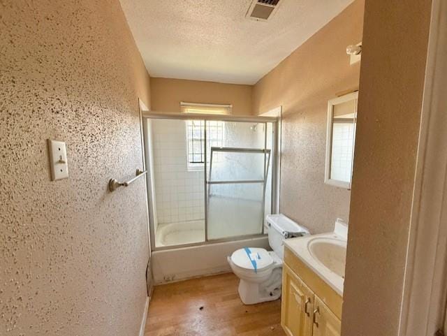 2340 Rex Pl, New Orleans, LA 70125 - bathroom with shower / bath combination with glass door, visible vents, a textured wall, vanity, and a textured ceiling