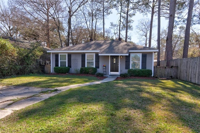 view of front of house featuring a front lawn, a chimney, and fence