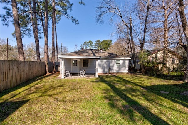 back of house with a patio area, a fenced backyard, and a lawn