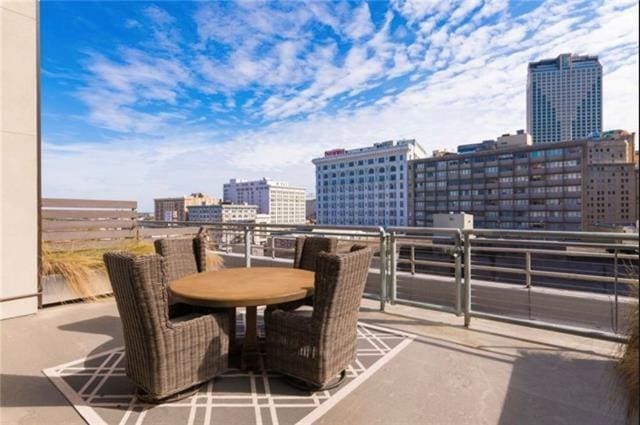 view of patio / terrace with outdoor dining space and a city view