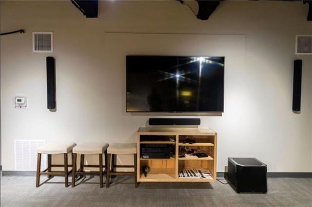 interior space with carpet, visible vents, and baseboards