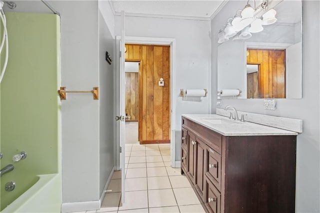 full bath with washtub / shower combination, baseboards, vanity, and tile patterned floors