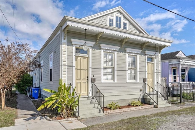 view of front of home featuring entry steps and fence