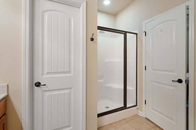 full bath featuring a stall shower, tile patterned flooring, and vanity