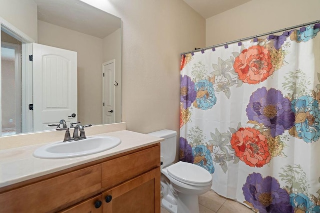 full bathroom featuring toilet, tile patterned flooring, and vanity