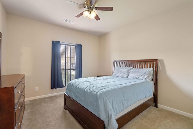 bedroom with light colored carpet, visible vents, and baseboards