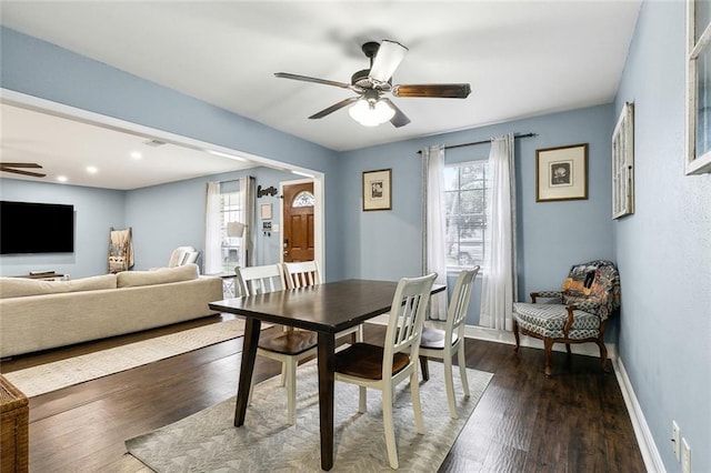 dining space with dark wood-style floors, ceiling fan, visible vents, and baseboards