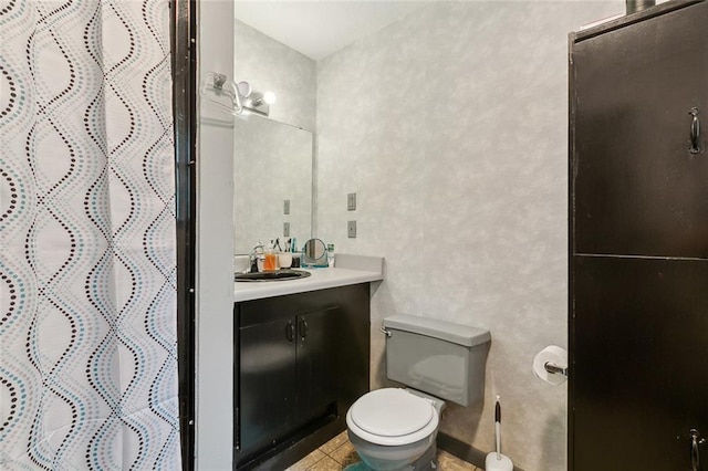 bathroom with toilet, a shower with curtain, vanity, and tile patterned floors