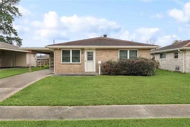 ranch-style house featuring a shingled roof, an attached carport, brick siding, and a front lawn