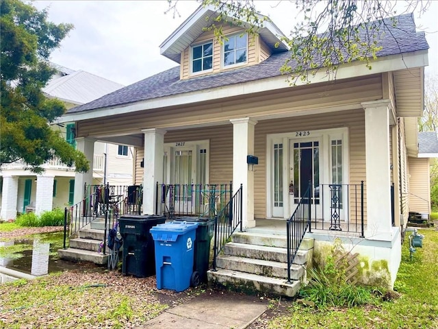 view of front of home featuring a porch and roof with shingles