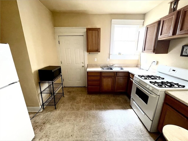 2425-27 Nashville Ave, New Orleans, LA 70115 - kitchen featuring white appliances, light countertops, and a sink