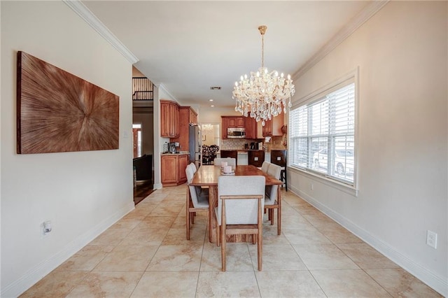 dining space with baseboards, light tile patterned floors, a notable chandelier, and crown molding