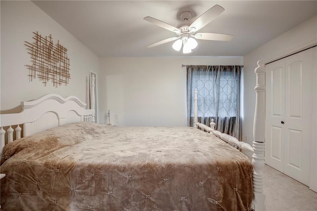 bedroom with light carpet, a closet, and a ceiling fan