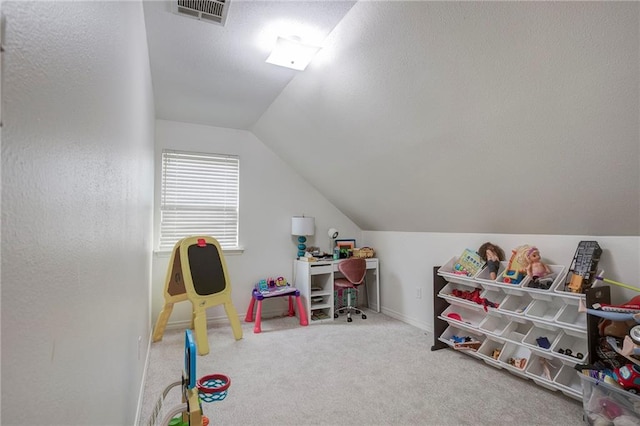 rec room with carpet, visible vents, and vaulted ceiling