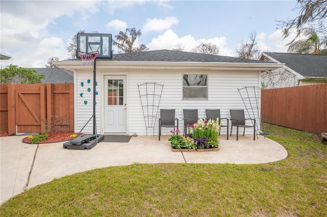 back of house featuring a yard, a patio area, and fence