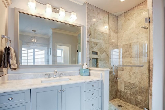 full bathroom with crown molding, a shower stall, and vanity