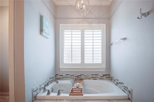 full bathroom with a chandelier, crown molding, and a jetted tub