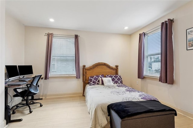 bedroom with light wood-type flooring, baseboards, and recessed lighting