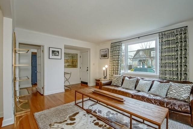 living area with wood finished floors and baseboards