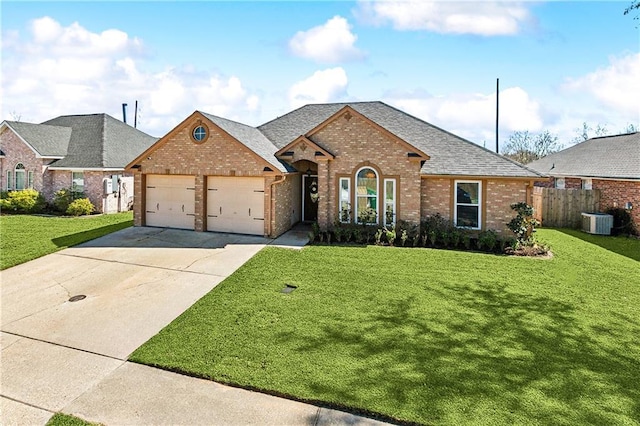 view of front of house with brick siding, a shingled roof, concrete driveway, cooling unit, and a front yard