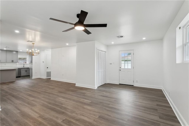 unfurnished living room featuring dark wood-style flooring, recessed lighting, visible vents, and baseboards