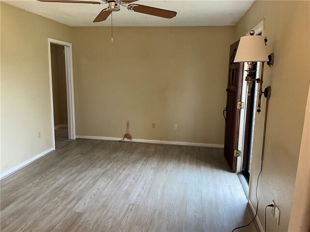 244 Waldo St, Metairie, LA 70003 - unfurnished room with baseboards, wood finished floors, and ceiling fan