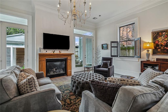 living area featuring visible vents, ornamental molding, a wealth of natural light, and wood finished floors