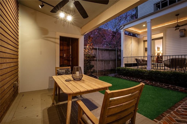 view of patio featuring ceiling fan, fence, and outdoor dining space