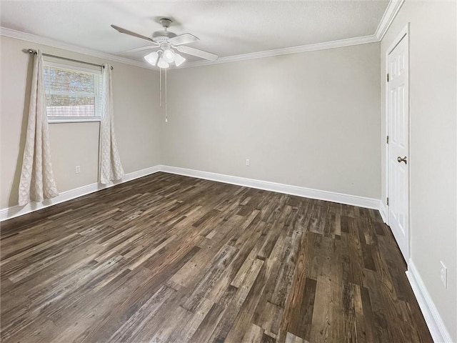 empty room featuring dark wood-style floors, ornamental molding, baseboards, and ceiling fan